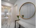 Bright hallway with marble floors, modern decor, and a decorative mirror at 13864 Destin Beach Ln, Orlando, FL 32827