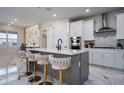Modern kitchen featuring a large island with seating, stainless steel appliances, and stylish pendant lighting at 13864 Destin Beach Ln, Orlando, FL 32827