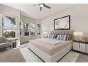 Bright bedroom with many windows, neutral walls, and a comfortable bed with stylish linens at 14841 Faversham Cir, Orlando, FL 32826