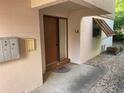 Condo entrance with front door, mailbox, and pea gravel landscaping at 170 Palmetto Woods Ct # 1A, Deltona, FL 32725