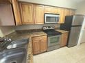 Functional kitchen boasts granite countertops, stainless steel appliances, and ample cabinet space at 208 Afton Sq # 307, Altamonte Springs, FL 32714