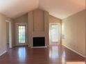 Bright living room features a cozy fireplace, patio access and wood floors at 208 Afton Sq # 307, Altamonte Springs, FL 32714