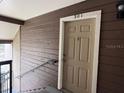 Unit 301 features a beige entry door on a brown wood-paneled wall at 224 Afton Sq # 301, Altamonte Springs, FL 32714