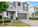 Charming two-story home features a two-car garage, brick paver driveway, and inviting covered porch at 2264 Emerald Springs Dr, Apopka, FL 32712