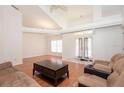Bright living room boasts hardwood floors, vaulted ceilings, and an abundance of natural light, creating an inviting and airy atmosphere at 23 Old Sunbeam Dr, South Daytona, FL 32119