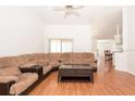 Spacious living room featuring hardwood floors and a large sectional couch, perfect for gatherings and comfortable everyday living at 23 Old Sunbeam Dr, South Daytona, FL 32119