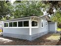 Charming exterior view showcasing gray siding, updated windows, and a well-maintained foundation at 232 W Lafayette St, Winter Garden, FL 34787