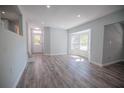 Spacious living room with bay windows, fresh paint, and recessed lighting at 237 W Mcclendon St, Lady Lake, FL 32159