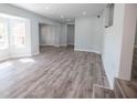 Bright, freshly painted living room featuring new floors and large windows at 237 W Mcclendon St, Lady Lake, FL 32159