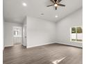 Bright and airy bedroom features wood-look floors, a ceiling fan, and a walk-in closet at 2426 Abbey Ave, Orlando, FL 32833