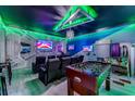 Amazing home theater and game room with surround sound, game tables, and vibrant custom lighting at 2609 Dinville St, Kissimmee, FL 34747