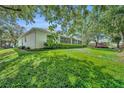 Spacious backyard features lush green grass and a screened-in patio for relaxing and entertaining at 288 Englenook Dr, Debary, FL 32713