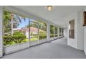 Enclosed patio featuring white railings and a view of the green backyard at 288 Englenook Dr, Debary, FL 32713