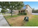 Inviting two-story home with well-maintained landscaping, front porch, neutral exterior paint, and lush shade tree at 3443 Berkshire Woods Ter, Deltona, FL 32725