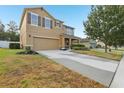 A two-story home with a spacious driveway, neutral paint, shutters, manicured landscaping, and a welcoming front porch at 3443 Berkshire Woods Ter, Deltona, FL 32725