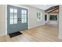 Bright foyer featuring new floors, a view of the front entry doors, and a modern ceiling at 40 W Laurel St, Apopka, FL 32703