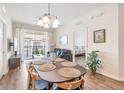 Dining room with decorative chandelier and sliding doors leading to the balcony at 4024 Breakview Dr # 40604, Orlando, FL 32819