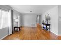 Spacious living room featuring gleaming hardwood floors and neutral paint at 4700 Larado Pl, Orlando, FL 32812