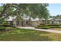 Charming single-story home with metal roof, stone accents, inviting porch and well manicured landscaping at 508 Yellow Submarine Ct, Groveland, FL 34736