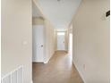 Inviting hallway with neutral paint, tile flooring, and access to various rooms at 536 Talisi Loop, St Cloud, FL 34771