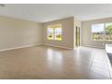 Bright living room with tile floors, large windows, and sliding glass door at 536 Talisi Loop, St Cloud, FL 34771