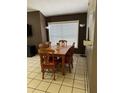 Cozy dining area with a wooden table and chairs, complemented by natural light from the window at 6518 Garden Spring Ct, Orlando, FL 32818
