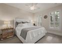 Comfortable bedroom featuring neutral tones, plantation shutters, a ceiling fan, and mirrored nightstands at 654 Mariposa St, Orlando, FL 32801