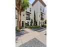 Elegant townhome exterior with clean lines, black accents, and lush landscaping at 654 Mariposa St, Orlando, FL 32801