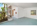 Spacious screened front porch with a white brick wall and entrance to the house at 819 Edgewater Dr, Eustis, FL 32726
