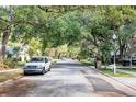 Scenic street view showcasing mature trees and well-maintained homes at 1039 Whispering Cv, Casselberry, FL 32707