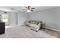 Comfortable living area with carpet, ceiling fan, and neutral paint at 1107 Monroe Ave, St Cloud, FL 34769