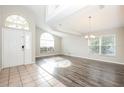 Open-concept living room featuring hard wood floors, a high ceiling, and natural light at 111 Spring Ridge Dr, Debary, FL 32713