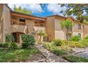 Well-maintained condo exterior with lush landscaping, private patios and walkways at 1111 Salerno Ct # Ge, Orlando, FL 32806