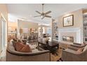 Open-concept living area with a fireplace, hardwood floors, and plenty of natural light at 11705 Binfield Ct, Orlando, FL 32837