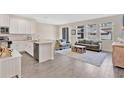 Open-concept living area featuring a modern kitchen with eat-in island and comfortable seating at 12079 Scrub Palm Ln, Orlando, FL 32824