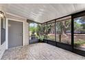 Enclosed patio with tiled floor and screened windows, offering a cozy outdoor living space at 1523 Casa Park Cir, Winter Springs, FL 32708