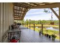 Spacious covered porch with seating and a view of the pond at 1526 Maytown Rd, Oak Hill, FL 32759