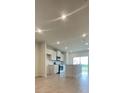 Open-concept kitchen with stainless steel appliances, an island with a sink, and sliding glass doors at 1904 Diamond Head Cir, Lake Hamilton, FL 33851