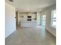 Open concept living area showcasing a kitchen island and lots of natural light at 1904 Diamond Head Cir, Lake Hamilton, FL 33851