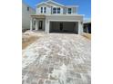 Charming two-story home with a modern design, spacious driveway, and neutral color palette at 1908 Diamond Head Cir, Lake Hamilton, FL 33851