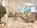 Well-lit living room with stylish furnishings, decor, and views into the kitchen and dining area at 2000 Golden Beak Dr, Eagle Lake, FL 33839