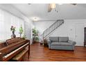 Inviting living room featuring hardwood floors and staircase at 2808 Revere Ct, Casselberry, FL 32707