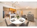 Dining room with tile flooring flows into the living room and kitchen with seating for four at a white round table at 2924 Jebidiah Loop, St Cloud, FL 34772