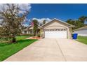 Home with two-car garage, well-maintained lawn, blue skies and American flag at 2924 Jebidiah Loop, St Cloud, FL 34772