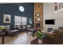 Inviting living room with a brick fireplace, comfortable sofas, and stylish decor at 3001 Little Cypress Cv, Winter Park, FL 32792