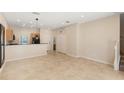 Bright living room with tile flooring and stairs to the upper level at 3064 Yellow Lantana Ln, Kissimmee, FL 34747