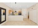 Bright living room with tile flooring, a modern pendant light and easy kitchen access at 3064 Yellow Lantana Ln, Kissimmee, FL 34747