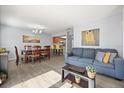 Open-concept living space with dining area, couch, bar seating, and view of the kitchen at 3118 Magic Kingdom Ct, Kissimmee, FL 34746
