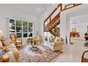Bright living room with vaulted ceilings, tile floors, and a large window offering a view of the landscaped yard at 3332 Stonewood Ct, Orlando, FL 32806