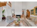Open living room featuring a fireplace, tall ceilings, and elegant furnishings, creating a cozy and inviting atmosphere at 3332 Stonewood Ct, Orlando, FL 32806